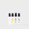 Four spray bottles of Blomb eau de parfum with black nozzles and colourful labels on a white background