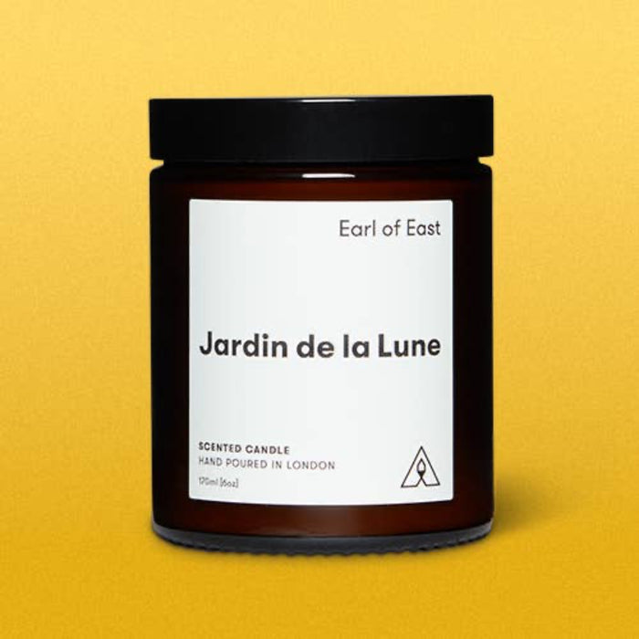 Candle jar labeled 'Jardin de la Lune' by 'Earl of East' on a yellow background
